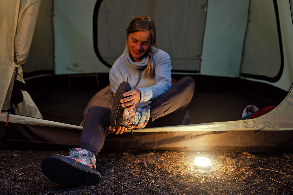 Camp shoes (pulling Outdoor Research booties off in tent)