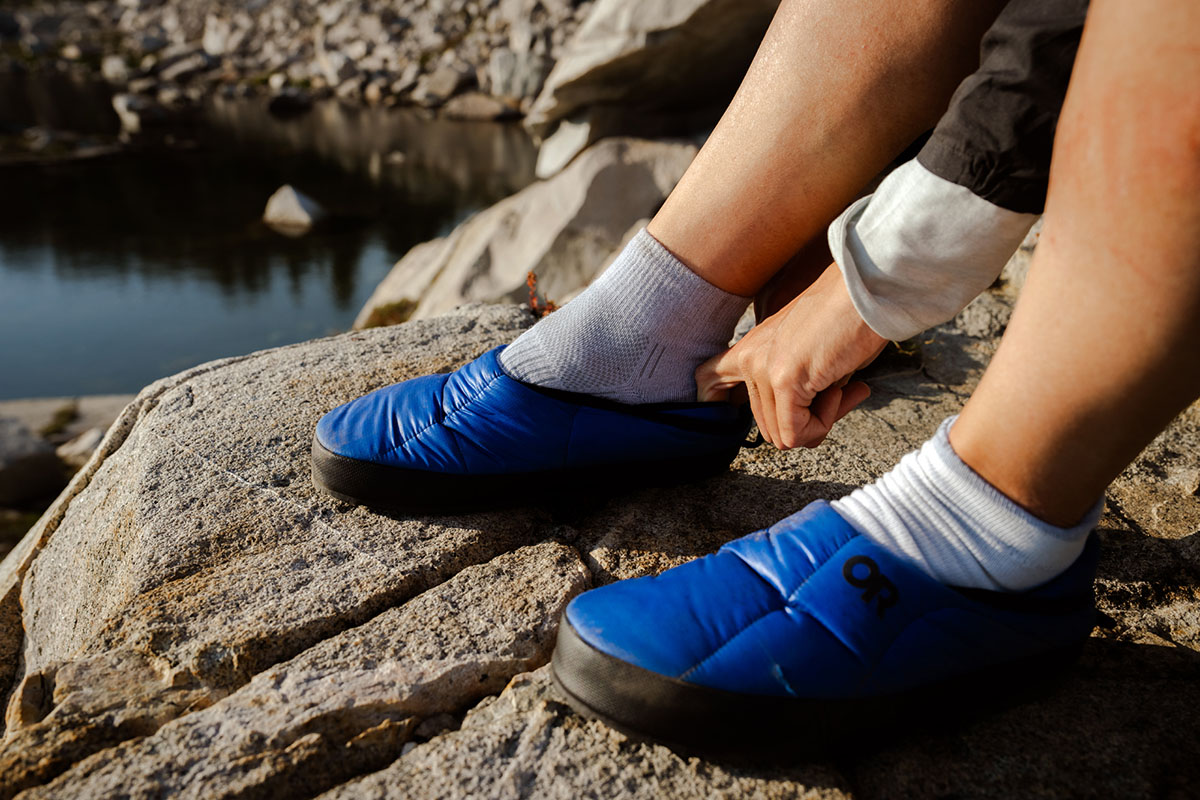 Camp shoes (putting on Outdoor Research Tundra Trax slippers)