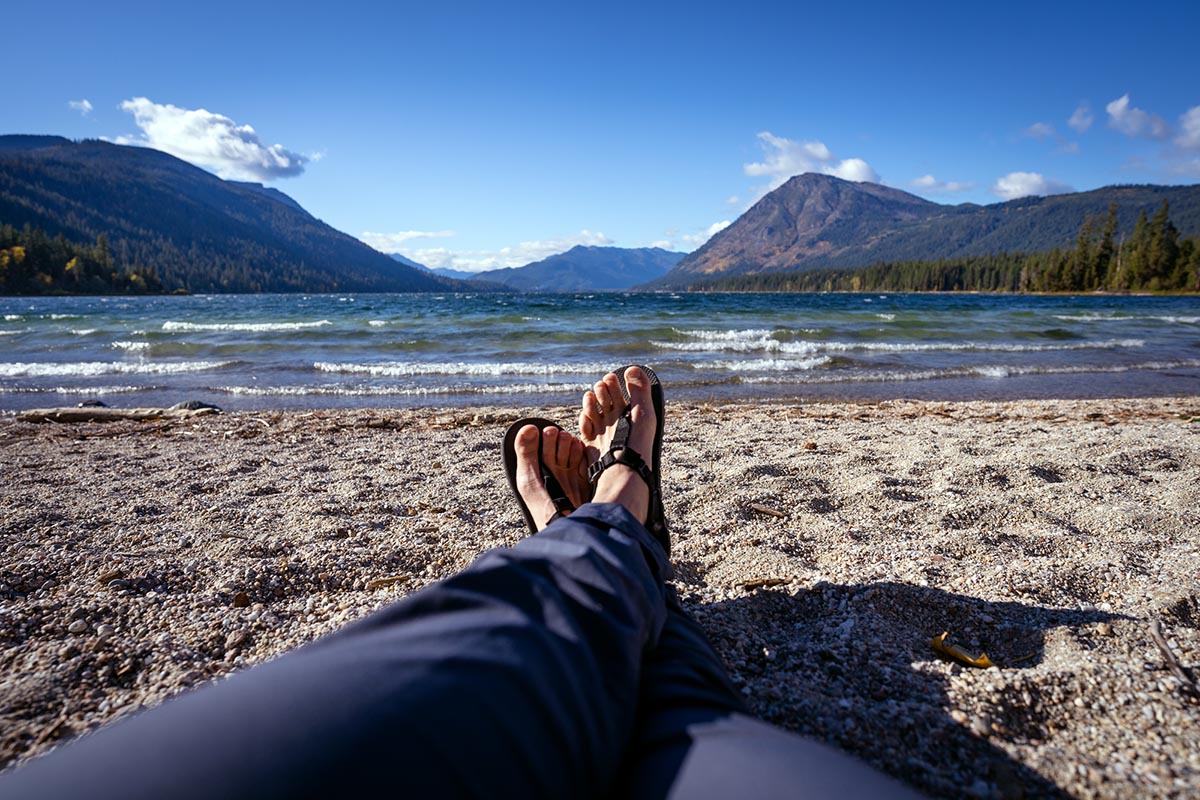 Camp shoes (sitting by water wearing Bedrock Cairn)