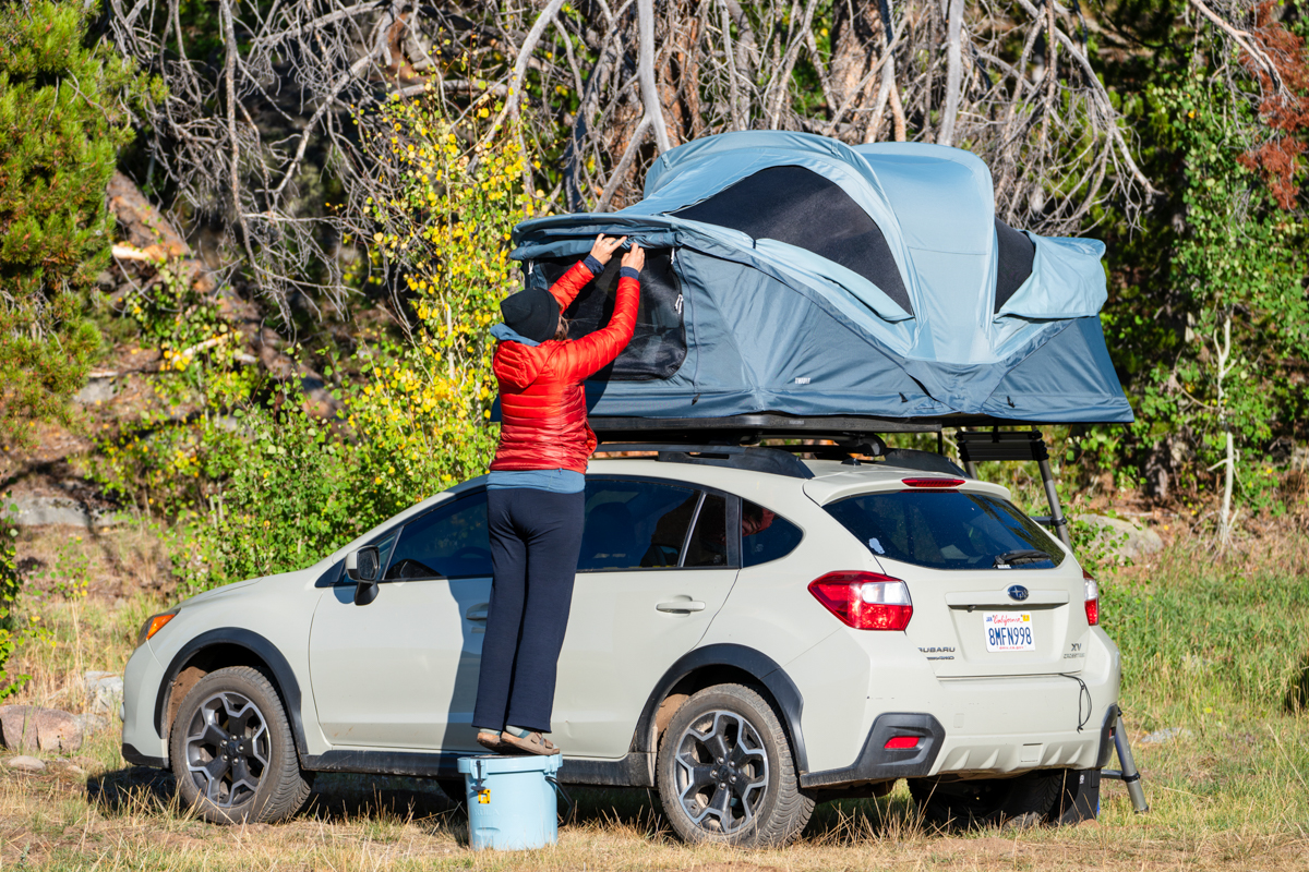 Cooler (standing on Bote Kula to open rooftop tent) 