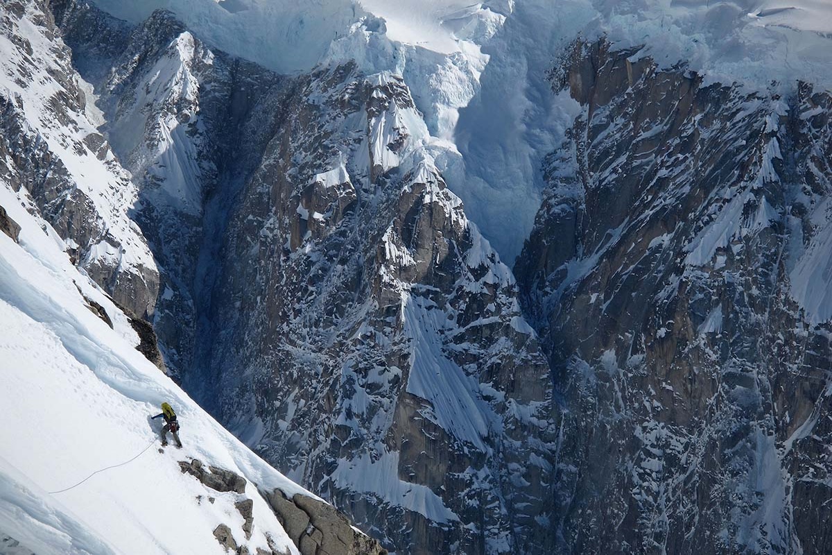 Mountaineering Boots (man climbing on large mountain)