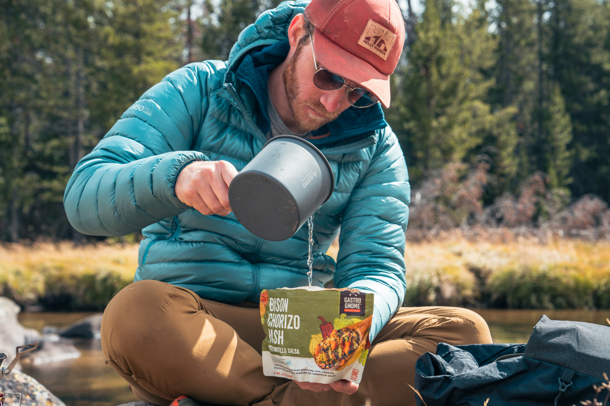 Backpacking food (pouring water into Gastro Gnome meal)