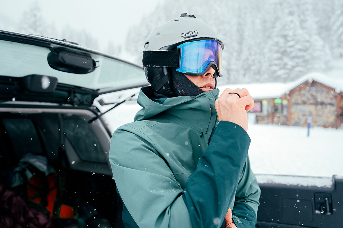 Men's ski jacket (zipping up REI First Chair)