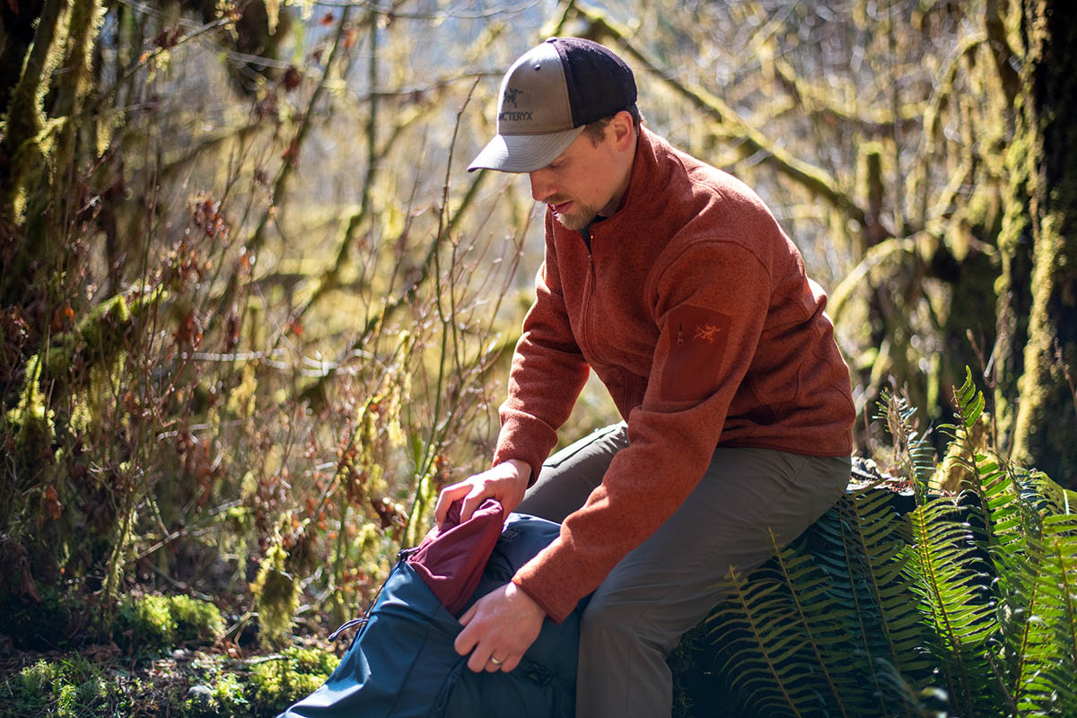 Arc'teryx Covert Cardigan Fleece (grabbing rain jacket from pack)