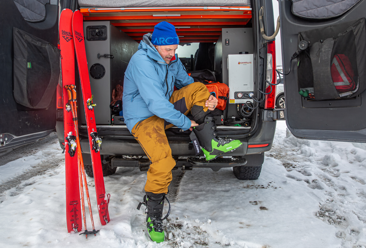 Men's ski bibs (putting on boots in van)