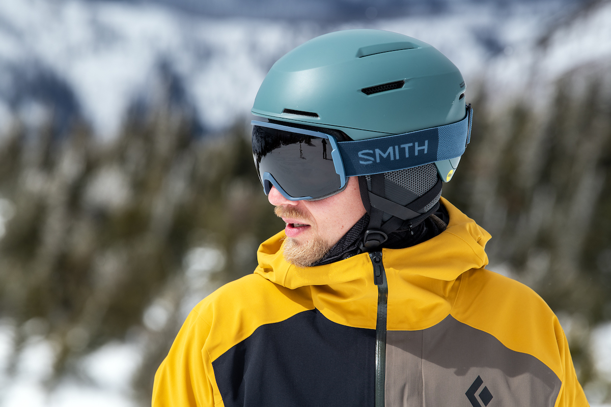 Side view snowboarder man wear black suit goggles mask hat ski