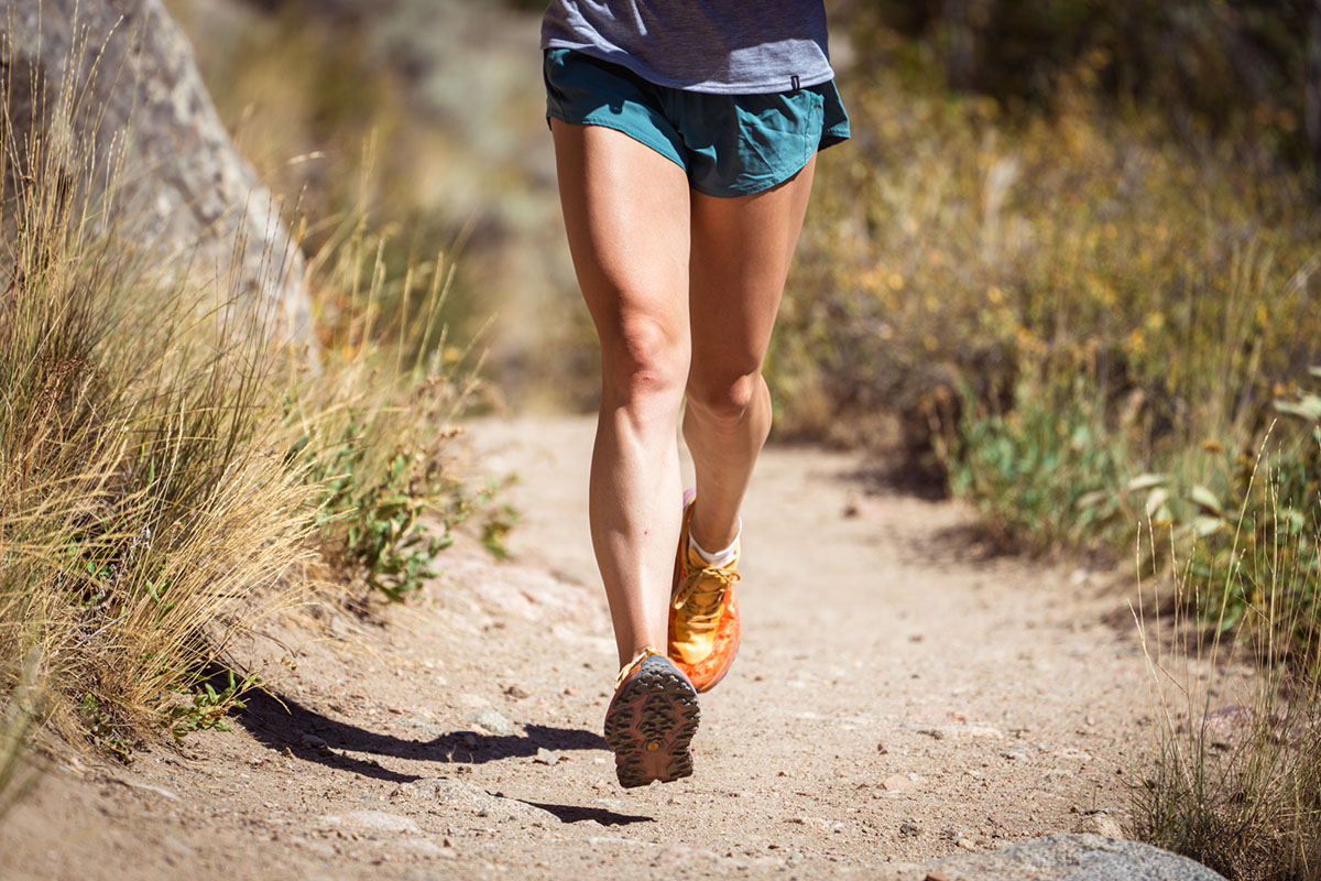 Trail running shoes (action shot of Hoka Speedgoat 6)