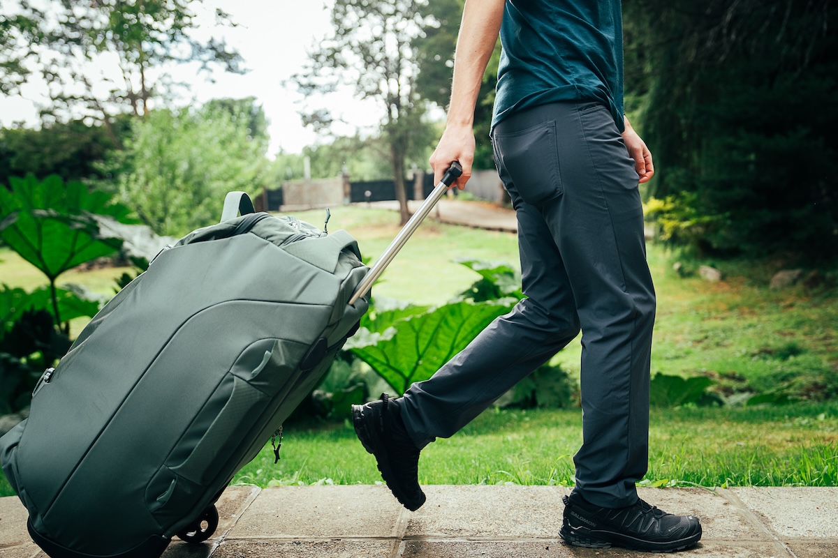 Men's Travel Pants (Walking with luggage down a sidewalk)