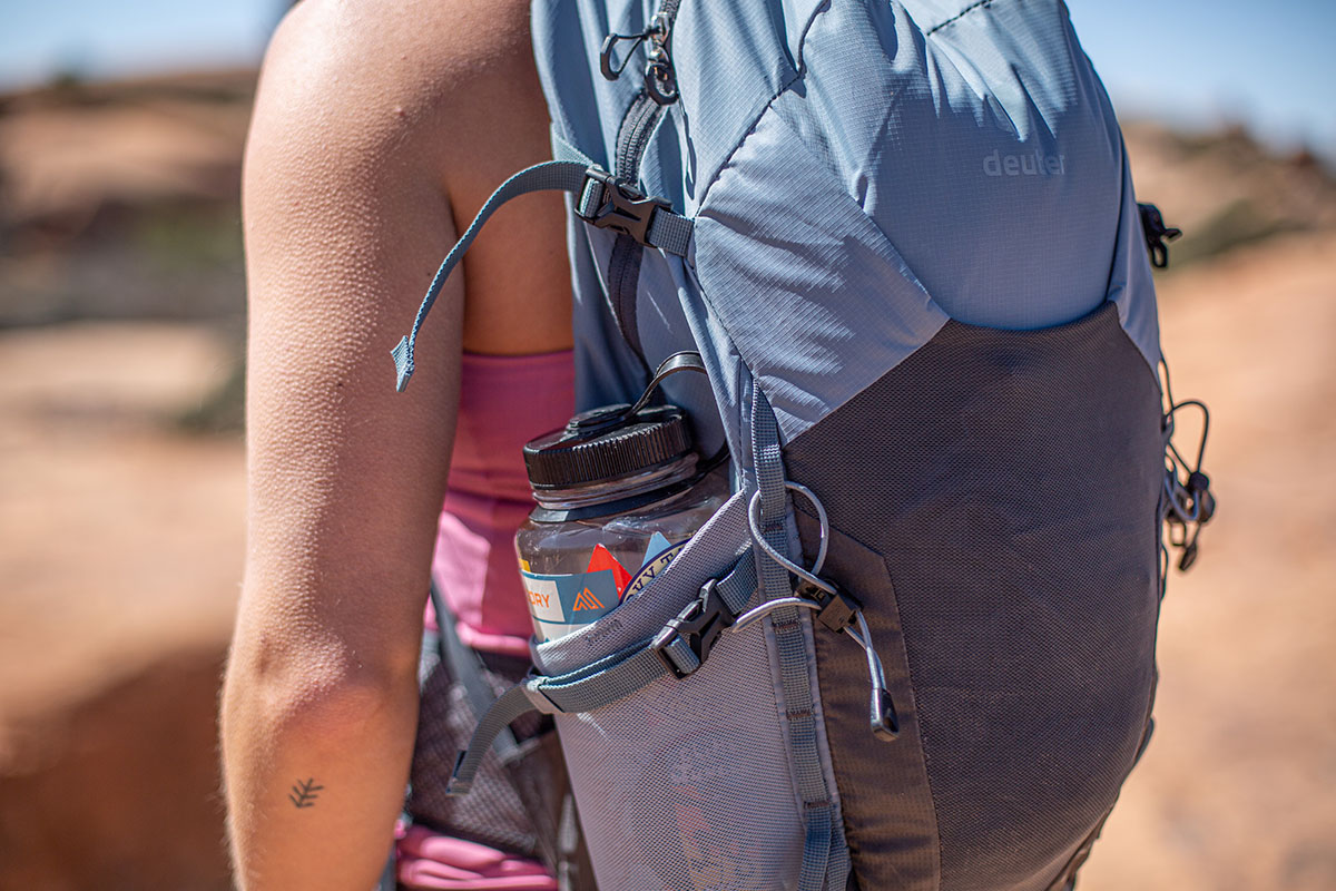 Women stay with Backpack with reusable water bottle in a pocket