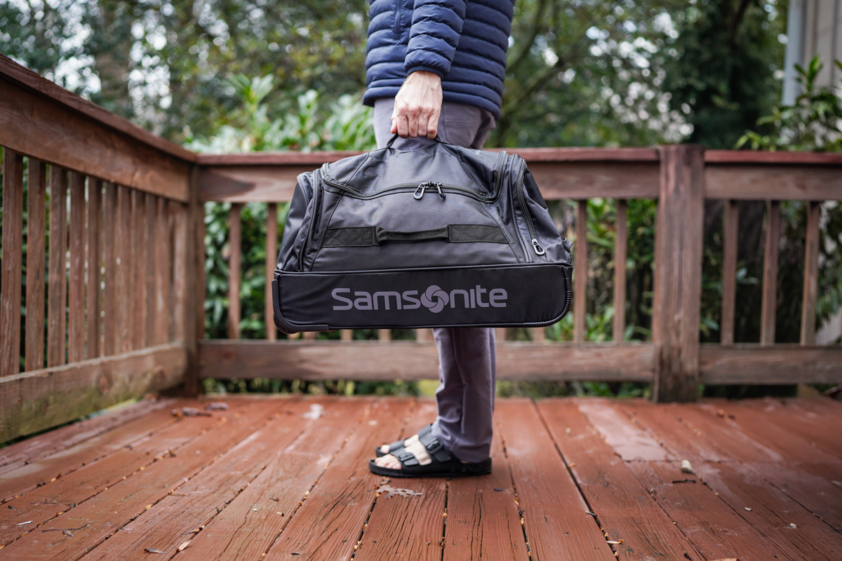 Wheeled Duffels (holding a wheeled duffel by the top handle)