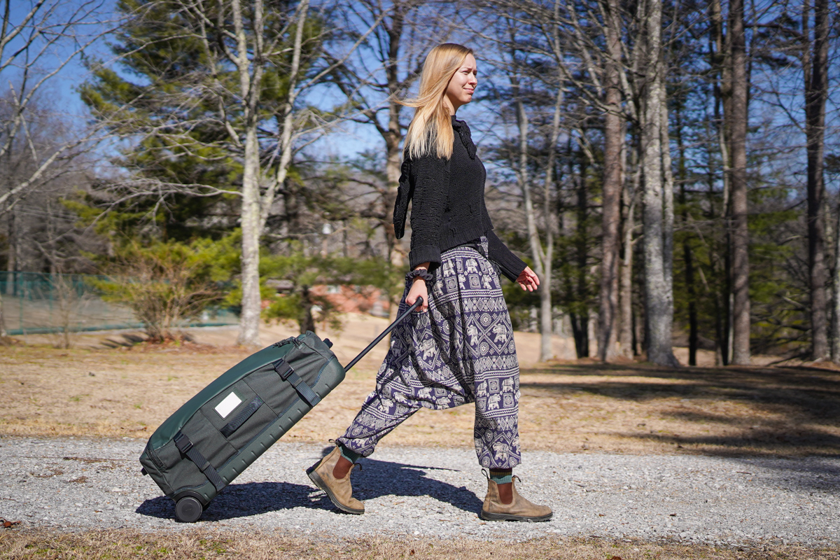 Wheeled Duffels (pulling the Away Outdoor Wheeled Duffel along a dirt road)