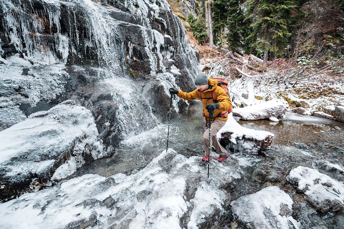 Walking on a frozen waterfall with winter traction device (winter boots)