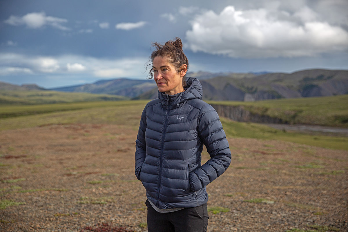 Women's down jacket (standing in mountains wearing Arc'teryx Cerium Hoody)