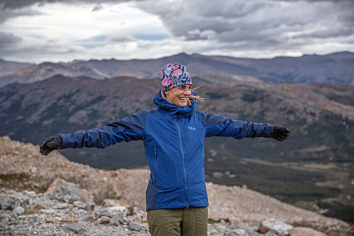 Women's rain jacket (standing in wind wearing Rab Kinetic Alpine 2.0)