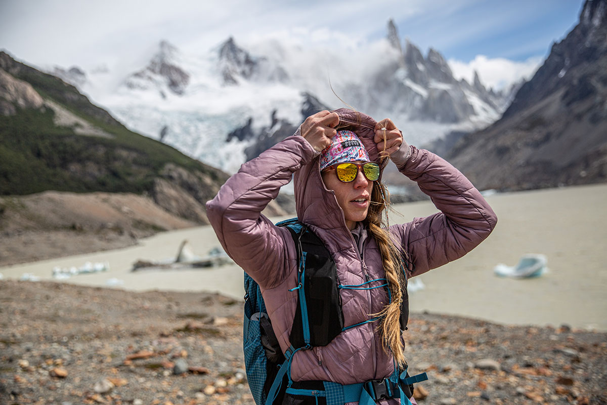 https://www.switchbacktravel.com/sites/default/files/image_fields/Best%20Of%20Gear%20Articles/Women%27s/Women%27s%20Synthetic%20Jackets/Outdoor%20Research%20SuperStrand%20LT%20Hoodie%20%28putting%20on%20hood%20in%20Patagonia%29.jpg