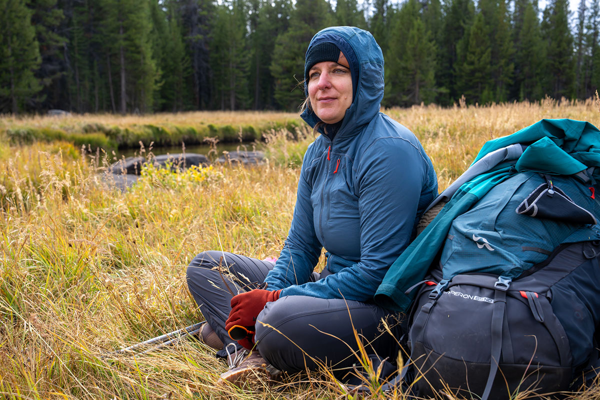 Women's fleece jacket (sitting next to pack wearing Rab Ascendor Summit Hoody)