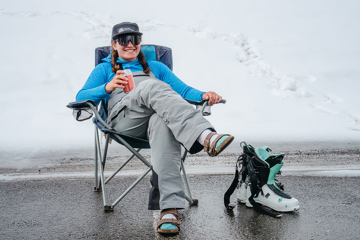 Ski Trip Packing Checklist (sitting with drink in camp chair)