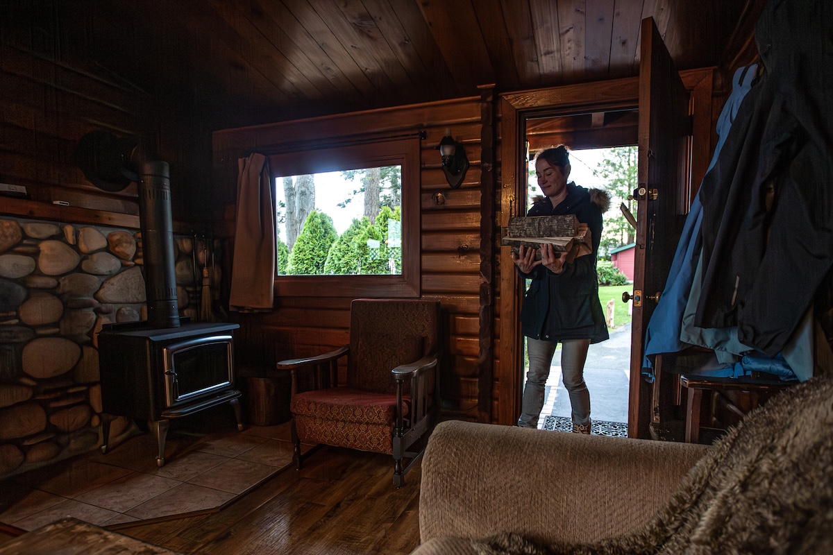 Carrying wood into the cabin wearing the Nuuk Parka