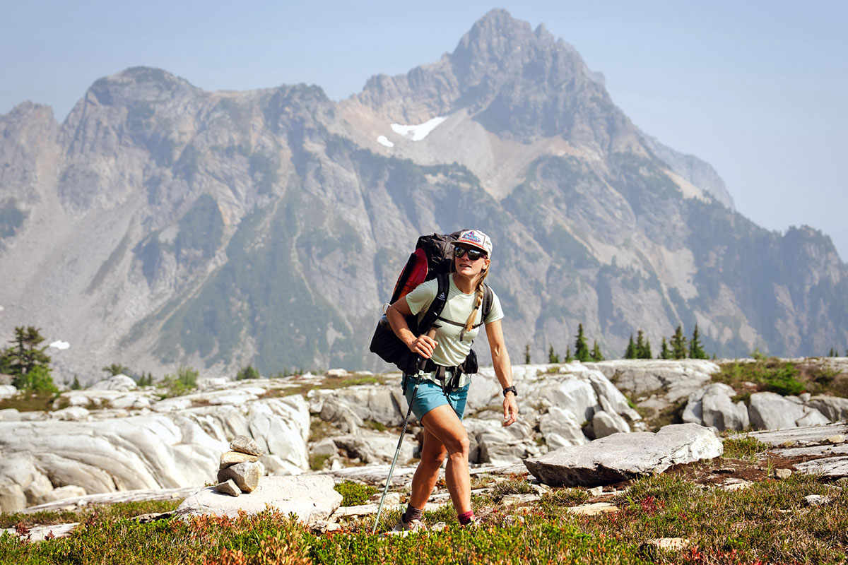 Woman Wearing A Hat And Sports Clothes Relaxing During A Mountain