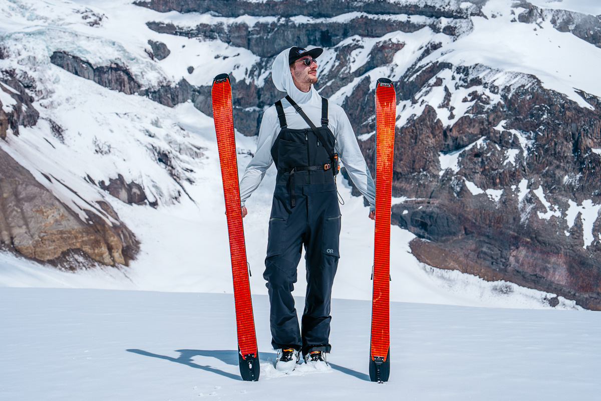 Outdoor Research Skytour AscentShell Bibs (holding skis on glacier)